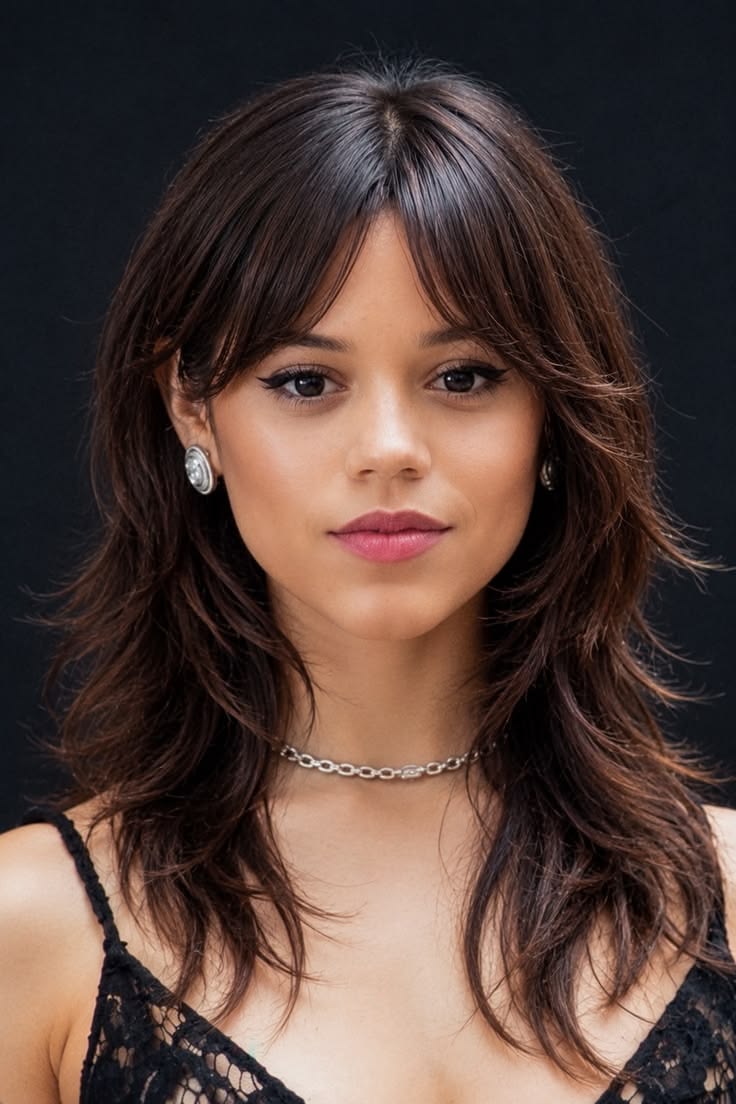 20 Layered Hairstyles That Instantly Add Volume and Movement (Wait Until You See #20!) - 18. The Dark Feathered Shag with Brow-Grazing Bangs 1
