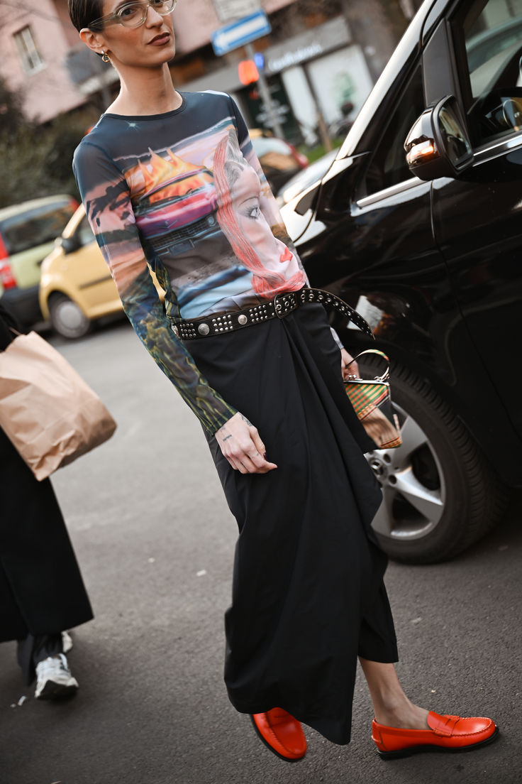 20 Milan Street Style Looks That Prove Italian Women Own Fall Fashion - 4. The Graphic Top That Makes a Black Skirt Feel New 1