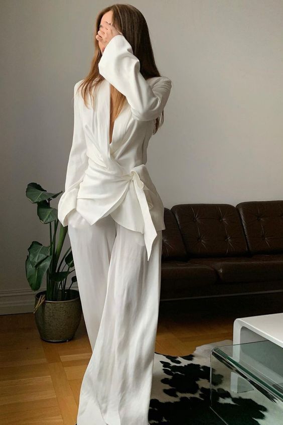 20 All-White Winter Party Outfits That Look Seriously Expensive (You’ll Want to Copy #7!) - 11. The Draped Wrap Blouse with Fluid White Trousers 1