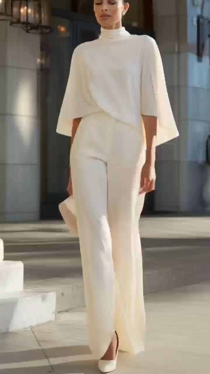 20 All-White Winter Party Outfits That Look Seriously Expensive (You’ll Want to Copy #7!) - 17. The Cape-Sleeve Top and Wide Trouser Evening Look 1