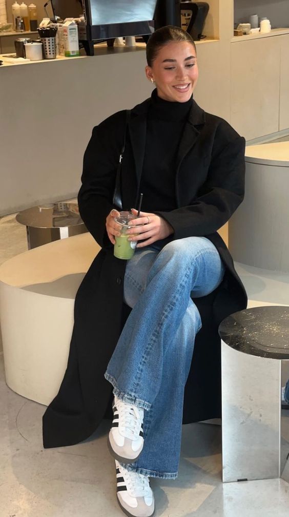 20 “I Just Threw This On” Winter Outfits That Look Anything But Random - 12. Black Coat, Black Knit, and the Perfect Blue Jean 1