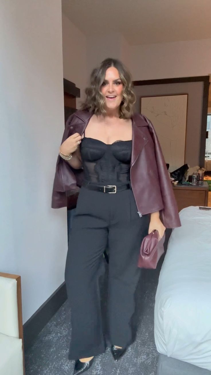 20 Plus-Size Winter Club Outfits That Bring the Heat (Even on the Coldest Nights!) - 19. Burgundy Leather Jacket Over a Black Jumpsuit 1